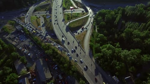 Cars Driving on Road Junction in Modern City at Summer Day. Aerial