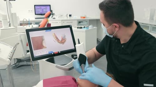 Dentist Scans the Patient's Teeth Using the CEREC Scanner Modern Dentistry The Dentist Uses a 3D