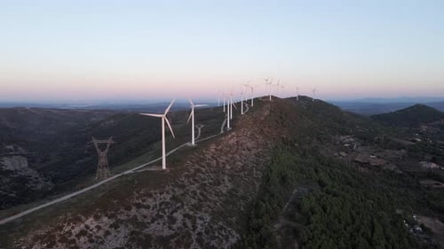 Wind turbines on hillside produce sustainable green energy Valencia Spain aerial