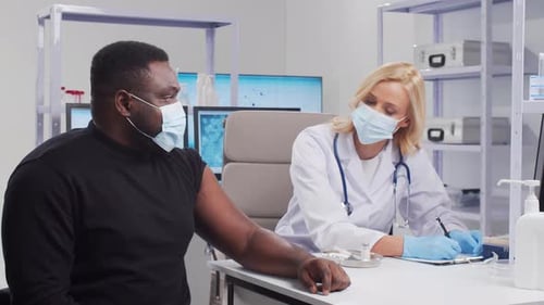 Doctor Giving Vaccine Injection to Man in Clinic