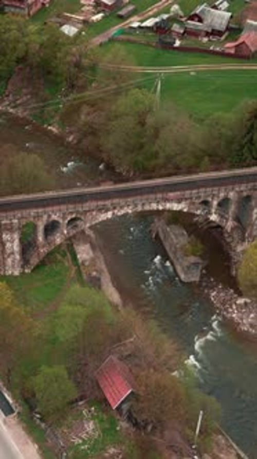 Old viaduct bridge across river in Vorokhta, Carpathians, Ukraine.Vertical video