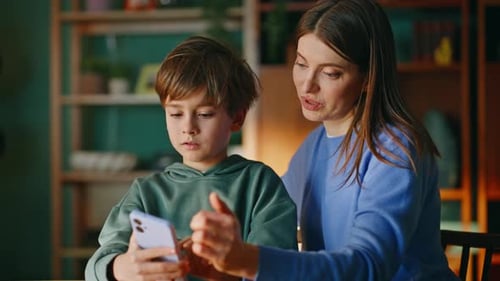 Mother and Son Using Smartphone at Home Together