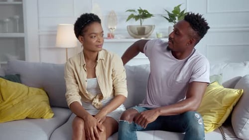 A Man and Woman Share an Intimate Conversation on a Couch