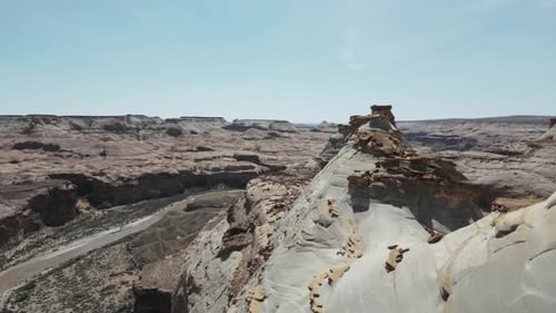 Soaring over Utah's majestic landscape, the barren expanse and canyon cliffs unfold beneath, showcas