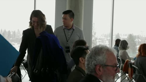 Conference Attendees Sitting Indoors Attending a Meeting