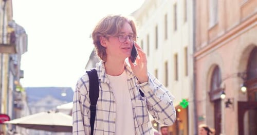 Young Male Student with Backpack Walking and Calling Friend in City Attractive Caucasian Guy in