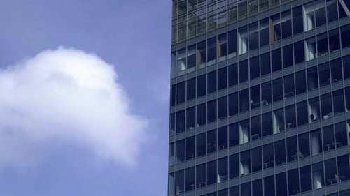 Modern Office Building Exterior with Glass Facade on Clear Sky Background