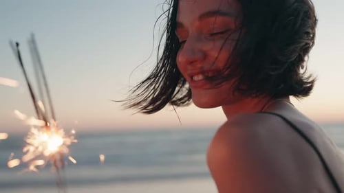 Woman with Sparkler at Beach