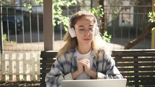 Woman on Laptop Video Call Outside