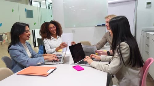 Coworkers Collaborating on Project in Modern Office