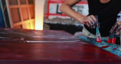 Caucasian Mature Woman Painting with Brush Inside Her Atelier Studio at Home Activity