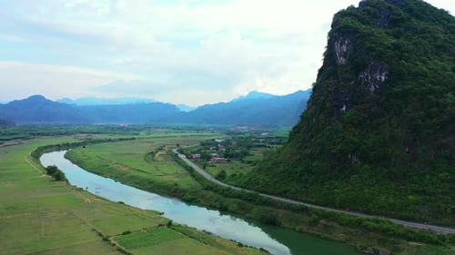 Drone, river and environment with nature, rural village and mountains with landscape