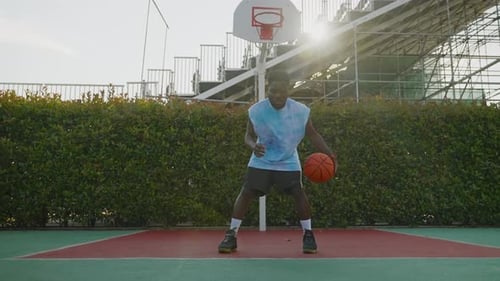 Basketball Training of Young Black Sporty Man Handsome Guy is Practicing Ball Control on Open Court