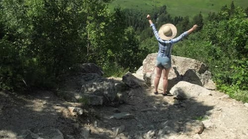 Person on Top of Mountain with Arms Raised Looking at View Hiker Enjoy Trip