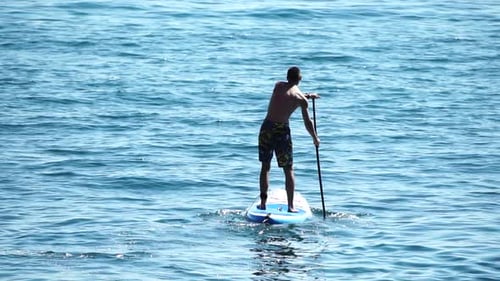 Man Sup Sea Strong Athletic Man Learns to Paddle Sup Standing on Board in Open Sea Ocean on Sunny