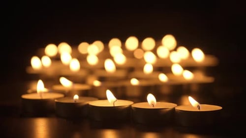 Tea Candles Burning in the Darkness