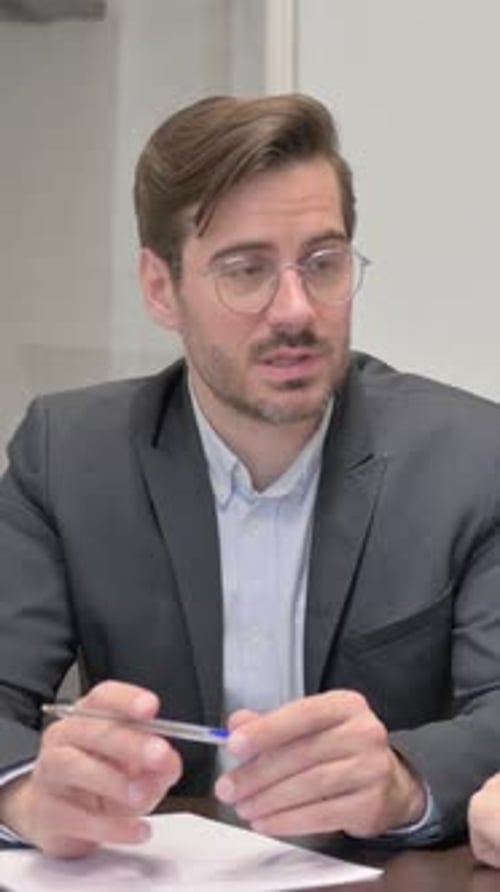 Professional Man Discussing Business Deals at Office Desk