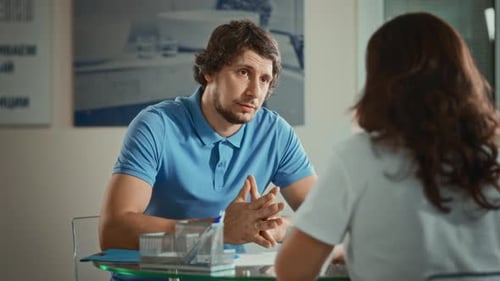 A Man Dressed in a Polo at an Interview in the Office A Woman Meets with a Potential New Employee to