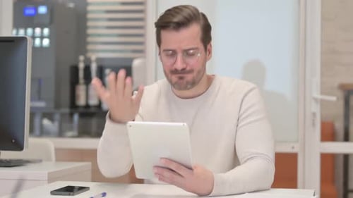 Frustrated Man Using Tablet in Office