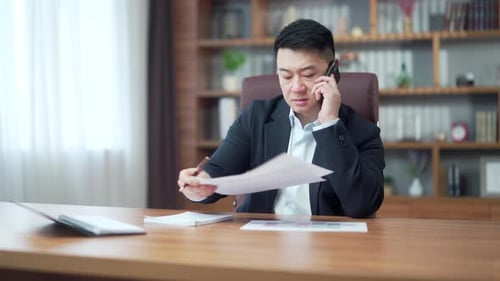 Man in Suit Talking on Phone in Office