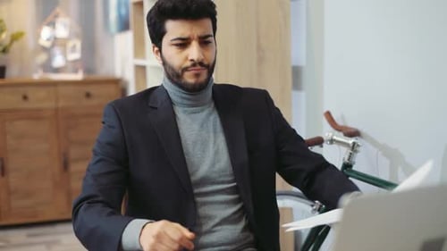 Goodlooking Man in a Cozy Office Carefully Reads the Documents Finds What He Was Looking for Snaps