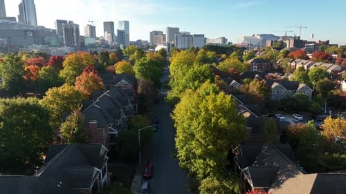 Aerial in autumn above treetops. Residential housing district in downtown Atlanta Georgia. Establish