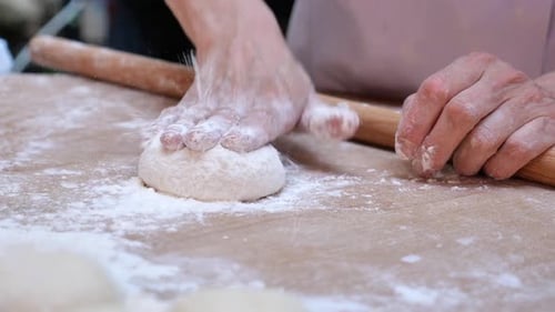 Chef Rolls Out Dough with Rolling Pin