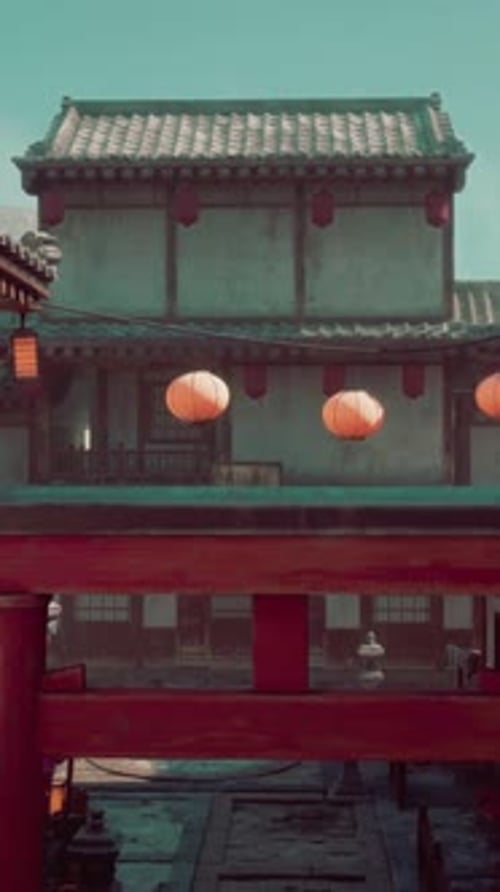 A Red Gate with Lanterns on Top of It
