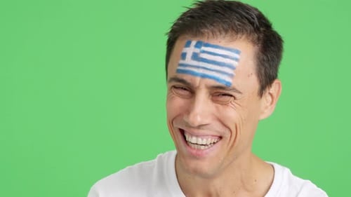 Smiling Man with Greek Flag Face Paint