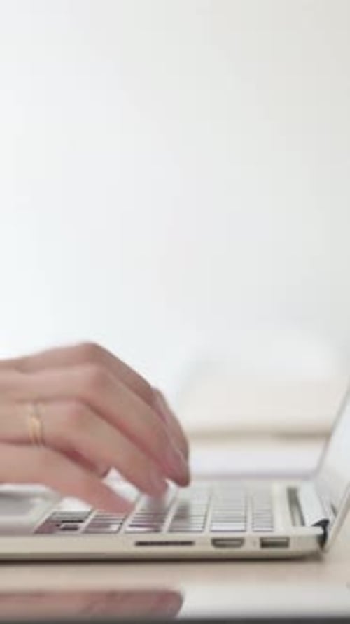 Close Up of Female Hands Typing on Laptop, Side View, Vertical Video
