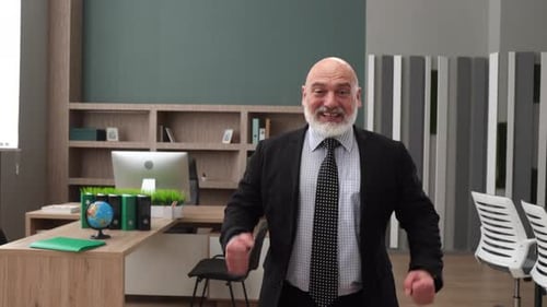 Excited Businessman Celebrating Success in Modern Office