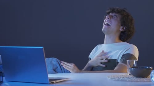 Smiling Man Laughing While Video Conferencing