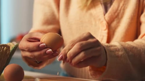 Hands Cracking Hard-boiled Egg On Surface And Peeling It. close-up shot