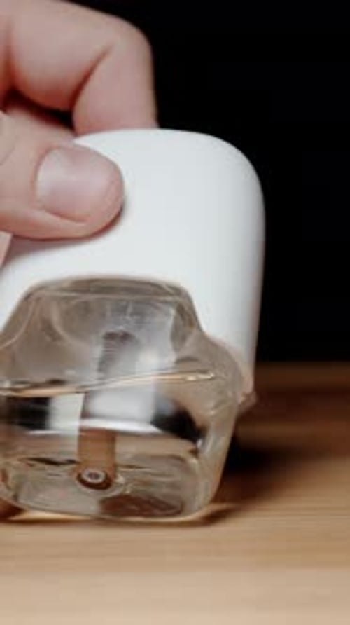 Hand Adjusting Aroma Diffuser Plug in Home Setting