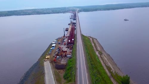 Aerial view of a long bridge crossing a wide river