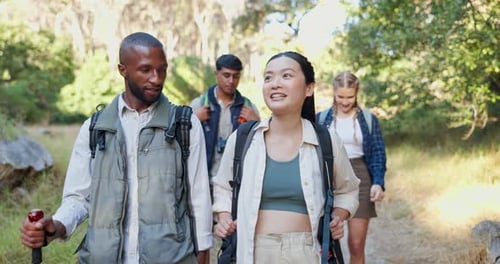 Friends Hiking on Wooded Nature Trail in Daytime