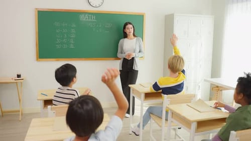 Group of student learn with teacher in classroom at elementary school.