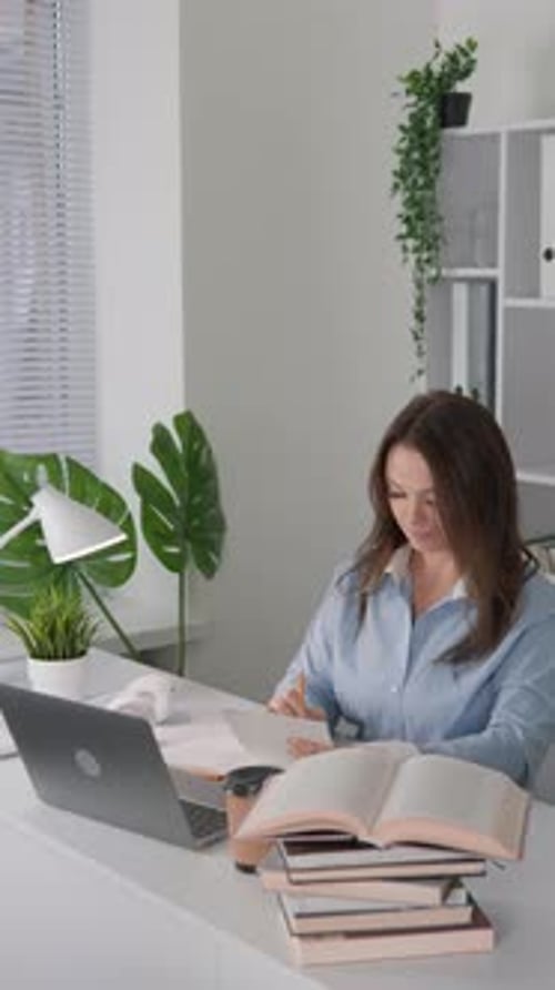 Woman Studying at Desk in Home Office