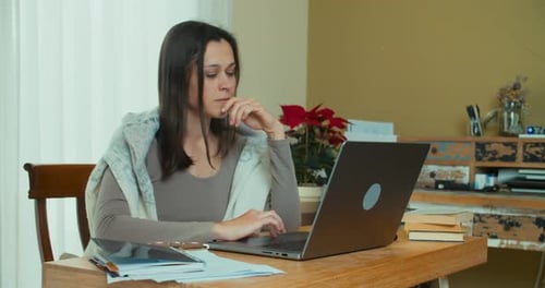 Woman Works at Laptop in Home Office