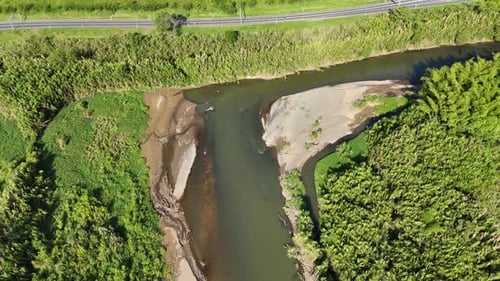 ndering river cutting through green wilderness