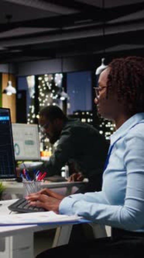 Vertical Video Black Woman Specialist Examine KPI Reports with Artificial Intelligence Tools