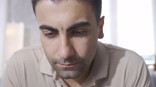 Young Man Contemplating Indoors