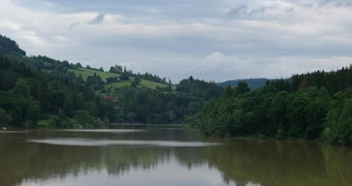 Lake Surrounded by Green Hills and Forests