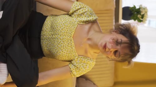 Woman Sitting on Couch Touching Head