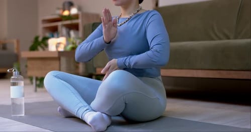 Woman Practices Yoga in a Living Room