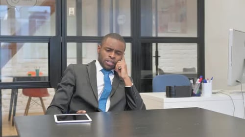 Man in Suit Talking at Office Table