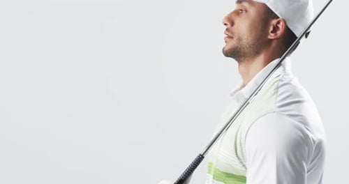Young biracial man poses with a golf club, with copy space