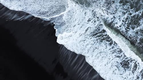 Aerial View of Black Sand Volcanic Beach with Crashing Waves Serene and Tranquil Landscape Famous