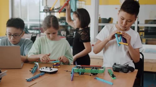 Students Building Robot at School in Class