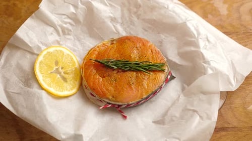 Seasoned Salmon Garnished with Lemon and Rosemary